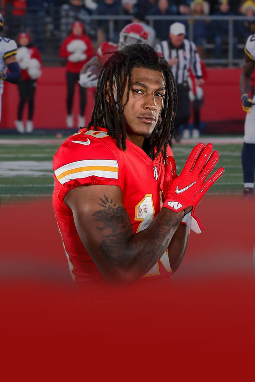 Isiah Pacheco in his Kansas City Chiefs uniform, celebrating on the field.